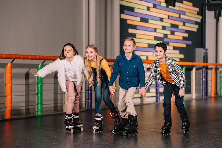 Four kids having fun roller skating in Minnesota.