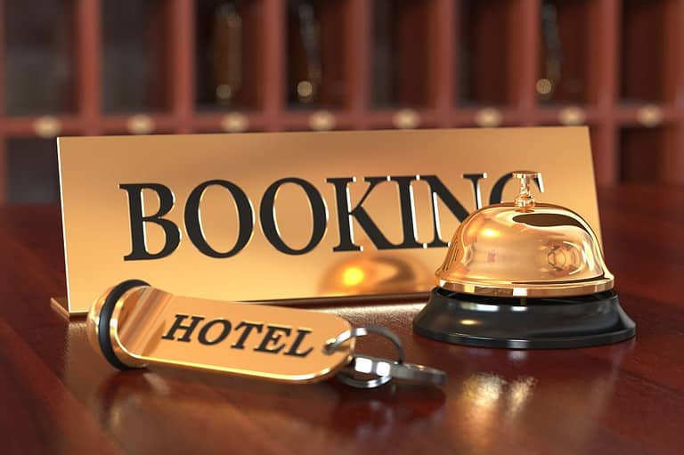 Classy looking hotel booking sign with hotel bell. Avoid these hotel mistakes.