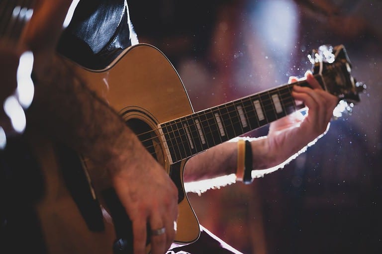Close up of a guitar player rocking out at Mid West Music Fest in Winona, MN