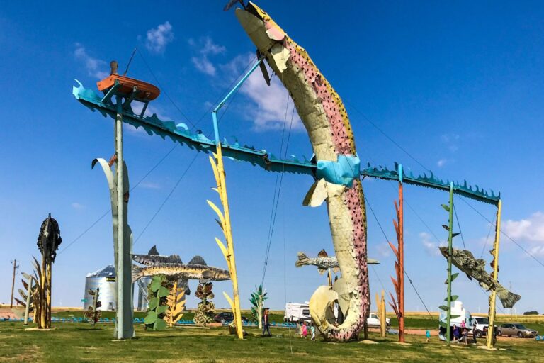 Folk art in North Dakota on a summer day with blue skies. Discover the charm of North Dakota's small towns! From Dickinson's outdoor adventures to Valley City's historic bridges, these hidden gems are waiting for you.