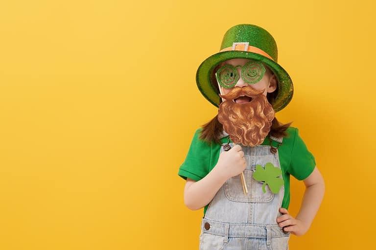 Funny little kid dressed like a leprechaun for St. Patrick's Day jokes