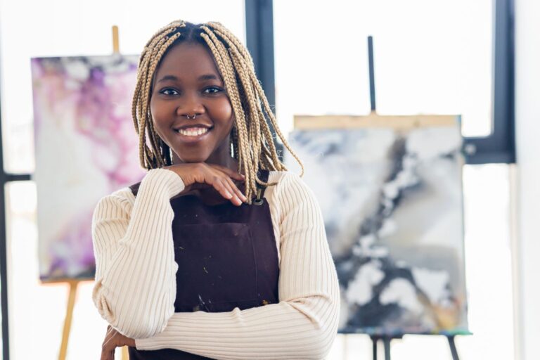 Young woman, African-American, in her artist loft studio. She is a visual artist and painter.