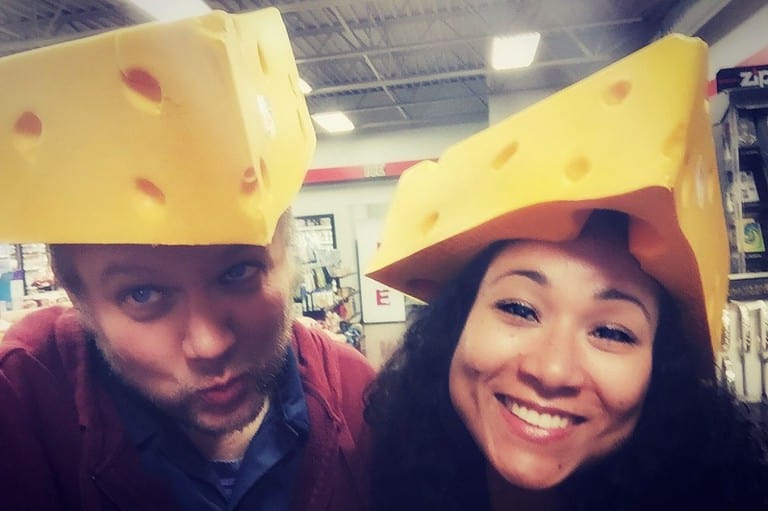 Emmy Award winning travel bloggers and best selling authors Jack and Kitty Norton wearing silly cheese hats on their heads.
