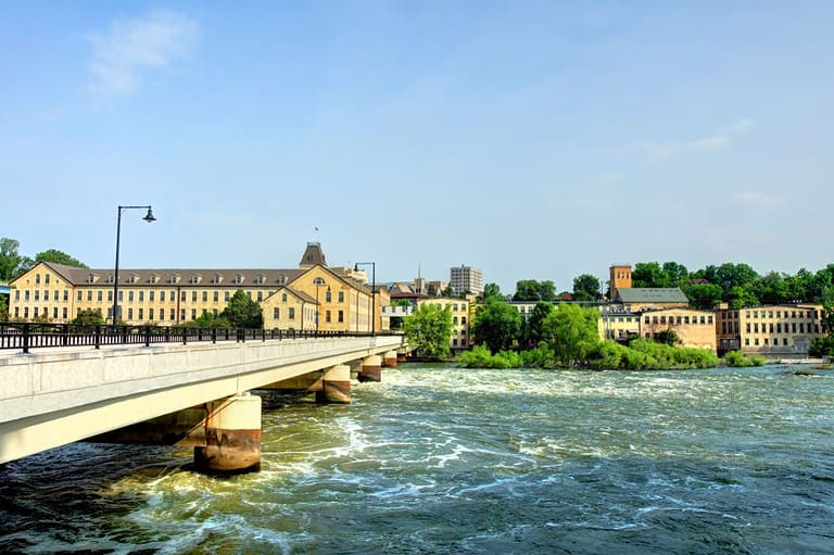 Wisconsin's Fox River flowing on a sunny summer day. Explore the enchanting charm of Wisconsin's river towns in 2024! These are our picks for must-see towns in the Land of Cheese.