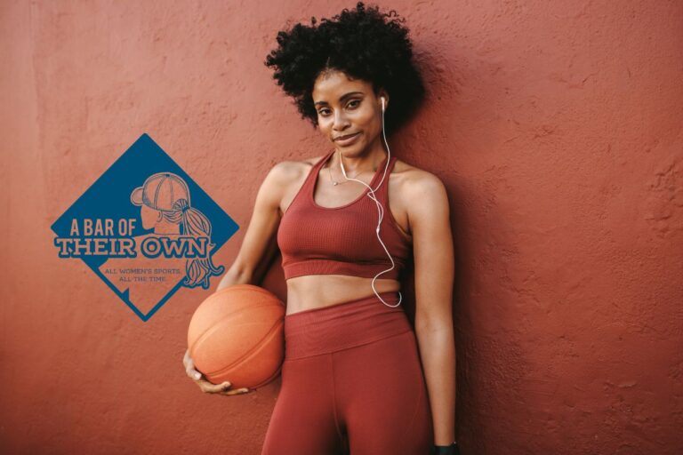 A sporty woman holds a basketball. Get ready to cheer for your favorite women's sports teams at Minnesota's first bar dedicated to women's sports, opening this week!