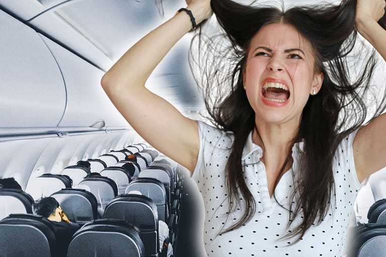 Annoyed woman on a plane. Airplane passengers driving you crazy? You're not the only one! Check out the most annoying fliers according to a new survey.