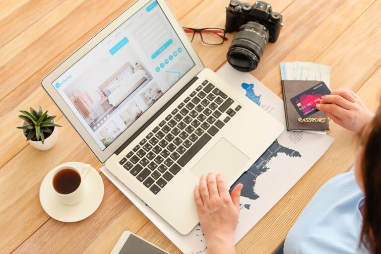 Woman booking a hotel on her laptop. Want to save big on your next hotel stay? The secret is all in the timing! We've got insider info that will save you big bucks!