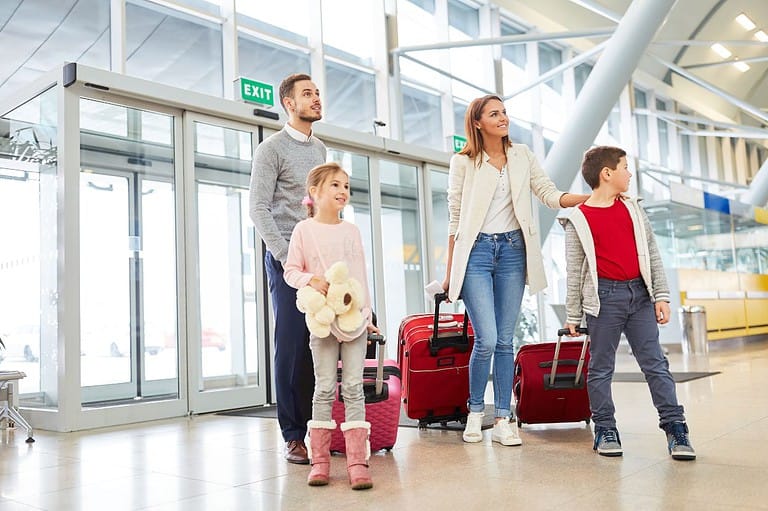 Family arrives at airport with luggage. Airlines are raking in billions from sky-high bag fees, but there's a simple way to avoid them! Learn the secrets behind checked bag fees.