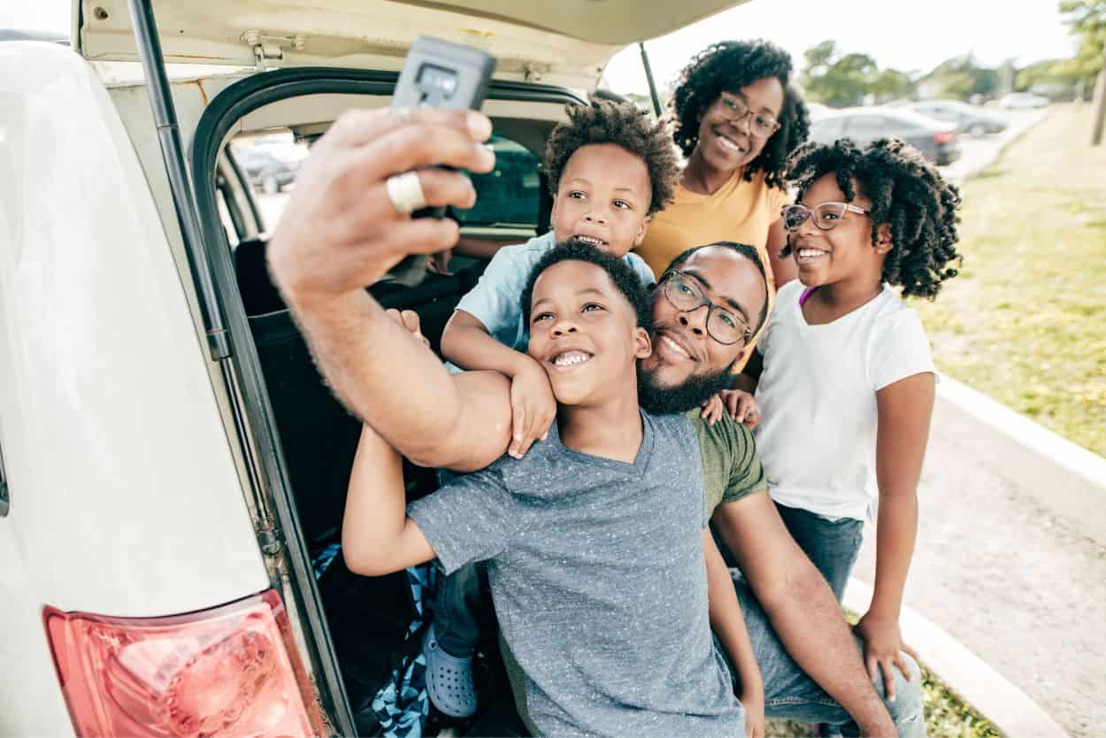 Detroit family poses for a selfie on a road trip. Get ready for some family fun with these 5 amazing day trips from Detroit, all under 90 minutes away and guaranteed to make memories!
