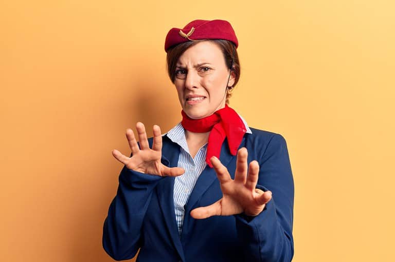 Flight attendant looks disgusted. Buckle up, germaphobes! We've got the dirty deets on the grossest spots on an airplane. It's about to get nasty up in here!