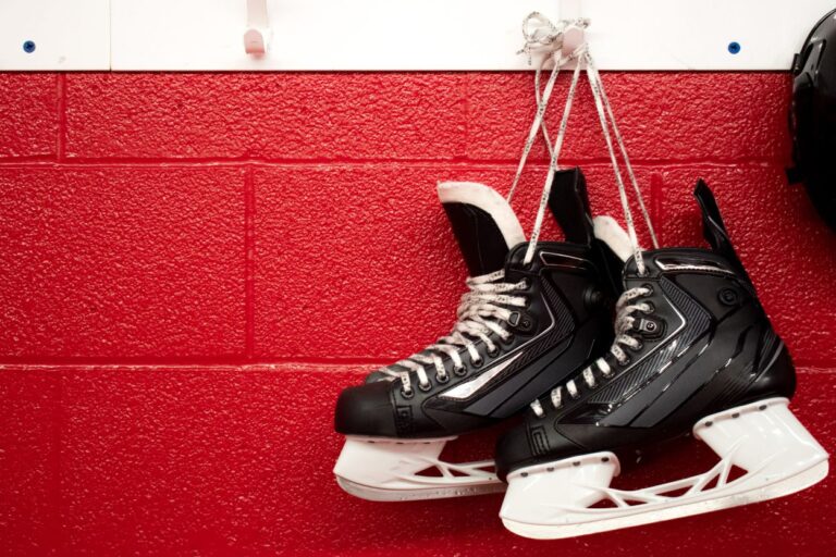 Pair of hockey skates hanging on a red wall. These are five places in Minnesota that you won't find anywhere else in the US! They are quirky, fun and totally unique to our state!