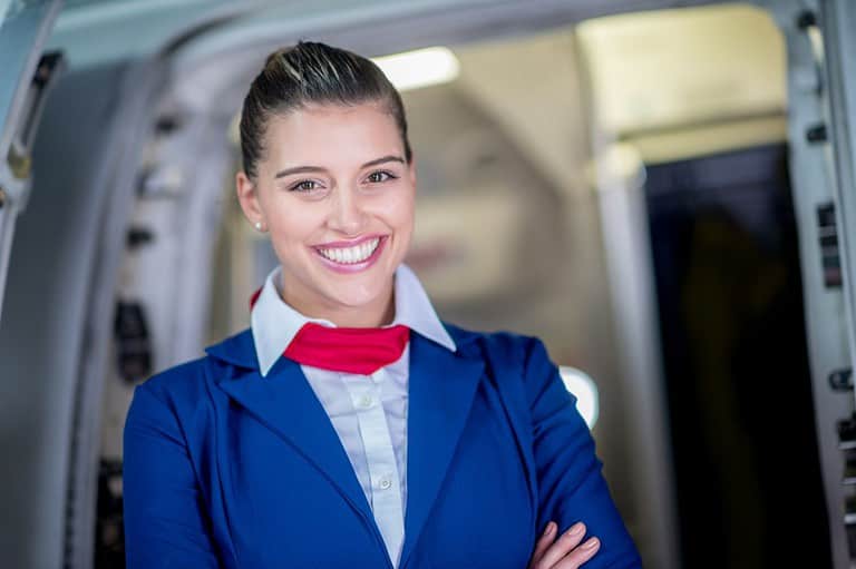Smiling flight attendant. You'll be shocked by the secret signals flight attendants are sending when they greet you at the plane door! Uff da!