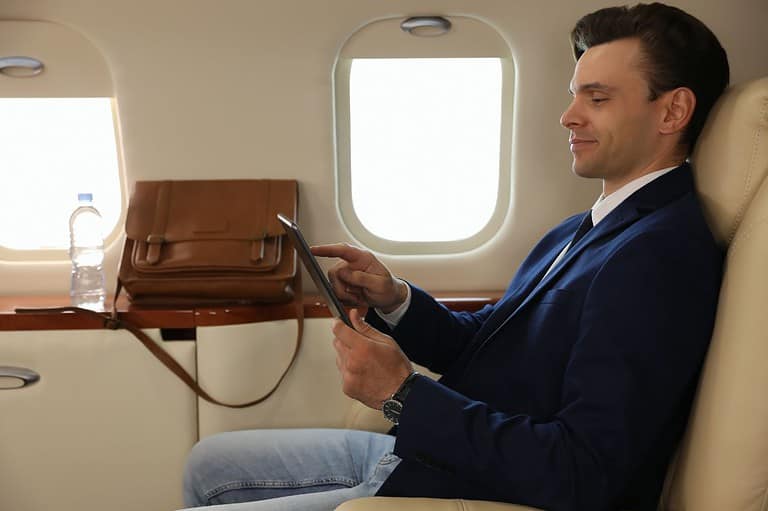 Happy man flying because he has lots of legroom. Say goodbye to cramped flights and hello to stretching out in style with this genius Google Flights hack they don't want you to know!