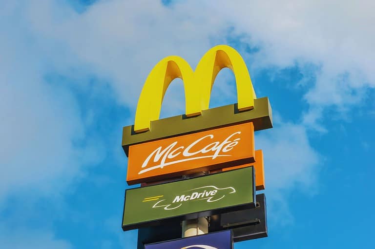 McDonald's sign with blue skies. It's a tiny town with a Big Mac! Did you know the world's smallest city with a McDonald's is in Minnesota? Find out where this is now.