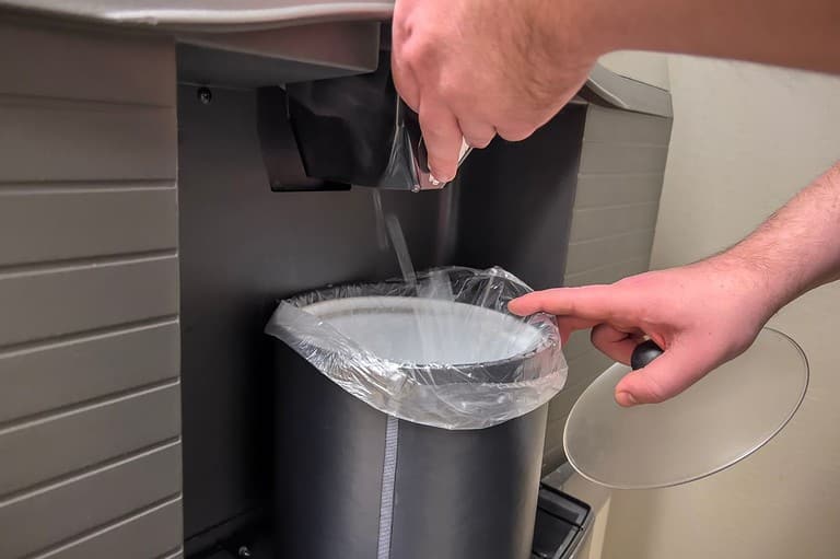 Man getting ice from an ice machine at his hotel. Discover the fascinating story behind free ice machines in hotels and how one man's vision changed the game!
