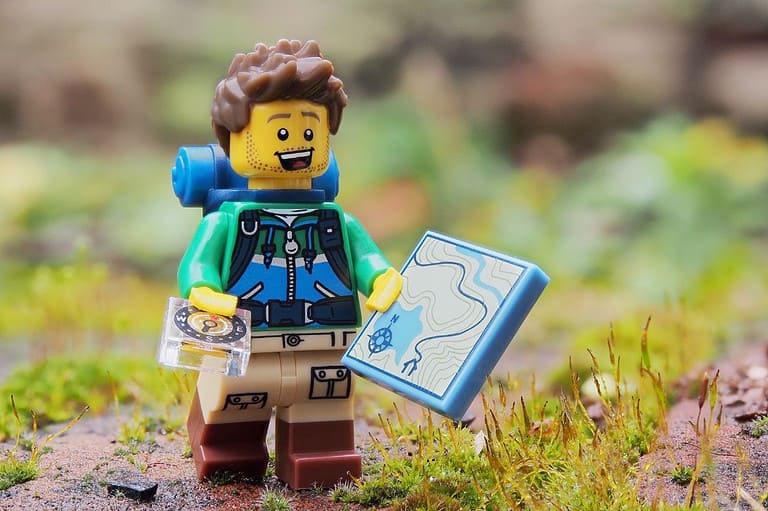 Lego man traveling with map. Discover the magic of Kansas City with your kids! From interactive museums to animal encounters, this Midwest gem has something for everyone.