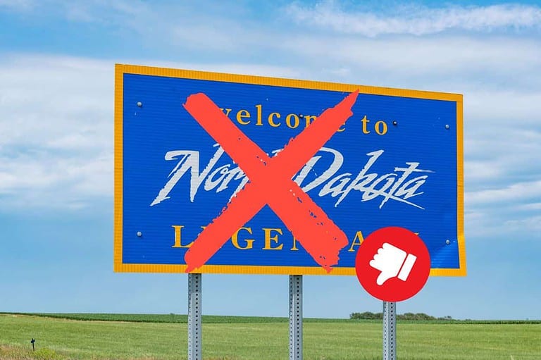 Welcome to North Dakota road sign crossed off with thumbs down emoji, Ready for some shocking revelations?! You won't believe the top 10 reasons why you should NEVER move to North Dakota!