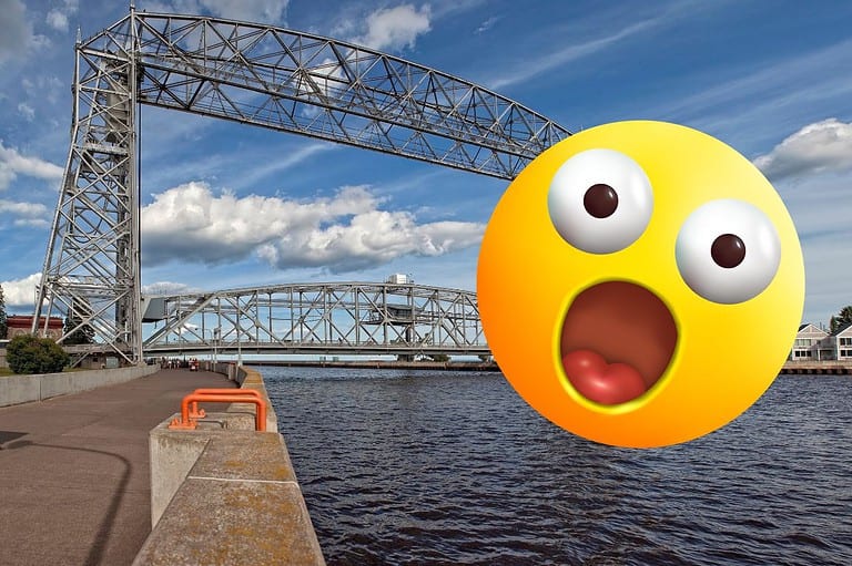 Aerial Lift Bridge in Duluth, MN with shocked emoji face. Ready to be shocked by Duluth, Minnesota? Discover 10 surprising things about this vibrant city that will leave you longing for more!