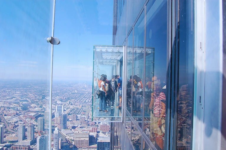 Group of tourists at Skydeck Chicago (Attribution-NoDerivs). Get ready to have your mind blown by the incredible views and fascinating facts at Skydeck Chicago, one of the Midwest's BEST attractions!