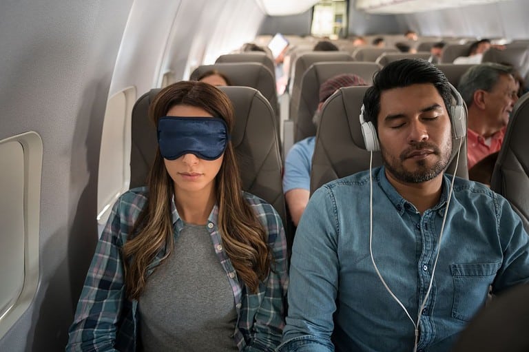 People sleeping on a plane. Want to sleep like a baby on your next long-haul flight? These game-changing tips from frequent fliers will have you feeling first class!