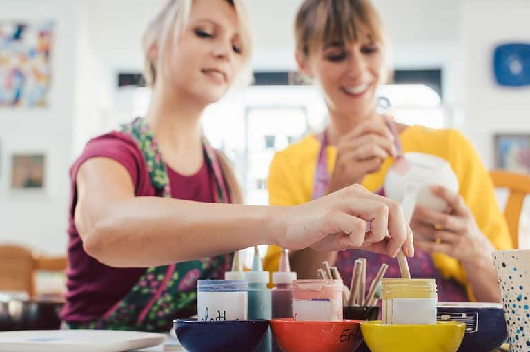 Two women enjoy a painting class. Get ready for the unexpected in Stillwater, Minnesota! From axe throwing to candle pouring, this town is full of wonderful surprises.