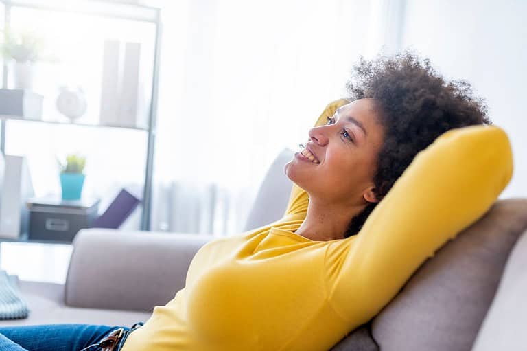 Woman relaxing stress free. Don't let these common (and totally silly) vacation mistakes ruin your trip! Read our top tips for a stress-free getaway.