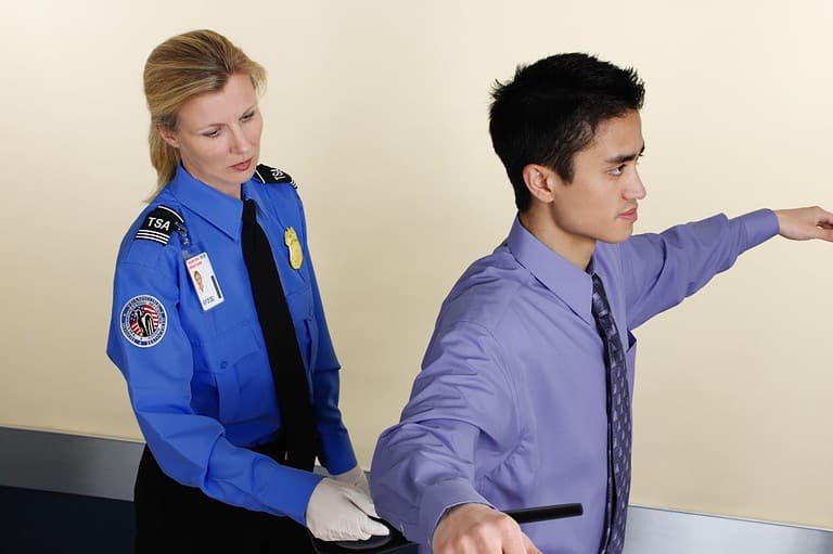 TSA Agent checks a traveler at MSP International Airport. These things drive TSA Agents crazy! Avoid doing them, and you'll breeze through airport security and keep your sanity.