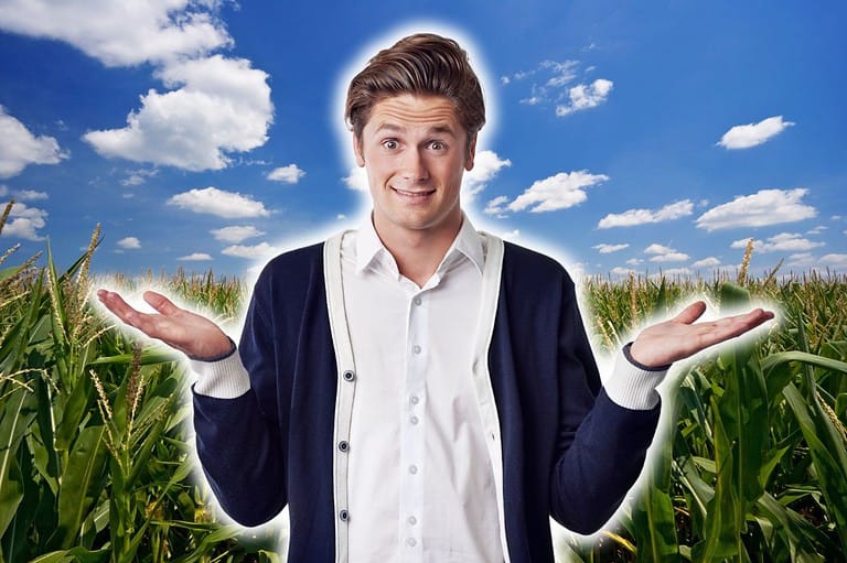 Confused man in a cornfield. Have you ever asked yourself: why is Nebraska called the Cornhusker State? Well, we've got the scoop on this corny nickname!