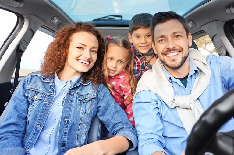 Missouri family driving in a van. Who's ready for a road trip? These 5 fantastic day trips from Springfield, MO are just a short drive away and packed with family fun!
