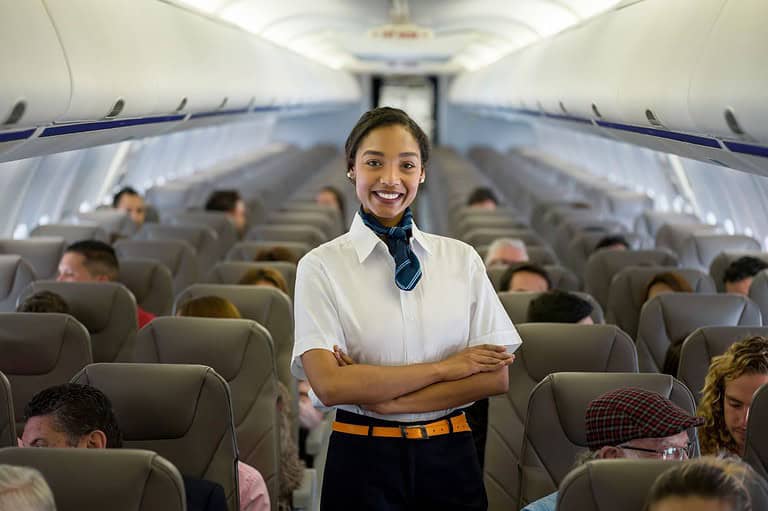 Flight attendant on plane. Have you ever wondered why cabin lights dim during takeoff and landing? Us too! The strange reason might surprise you!