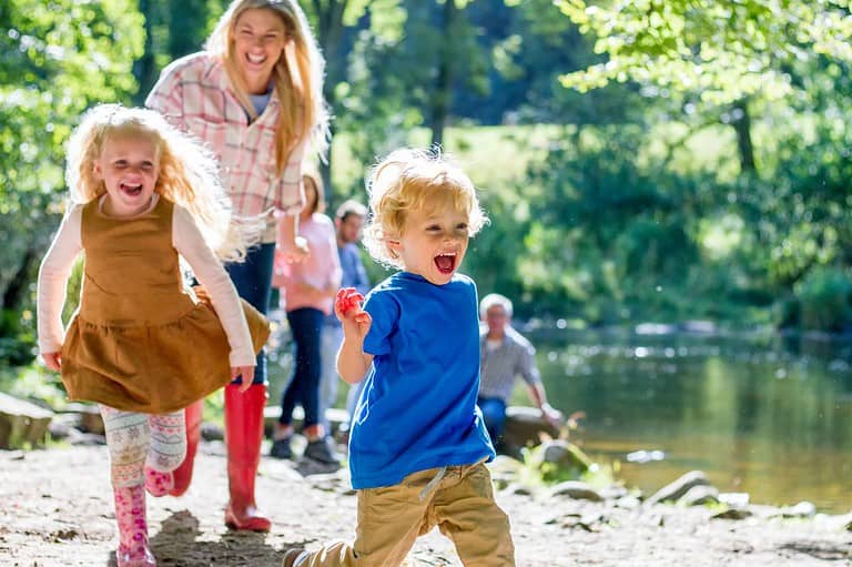 Minnesota family having fun at the lake, kids are very happy. Dive into the crystal-clear waters and sun-kissed shores of Minnesota's top beach and lake getaways – your ultimate fun destination awaits!