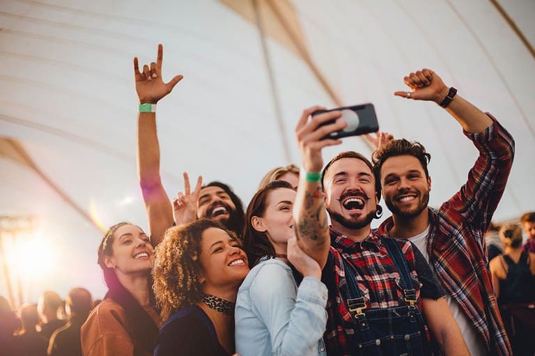 Fans having fun at a Minnesota music festival. Discover the soul-stirring sounds and electrifying celebrations that define Minnesota's music, concerts and festival scene.