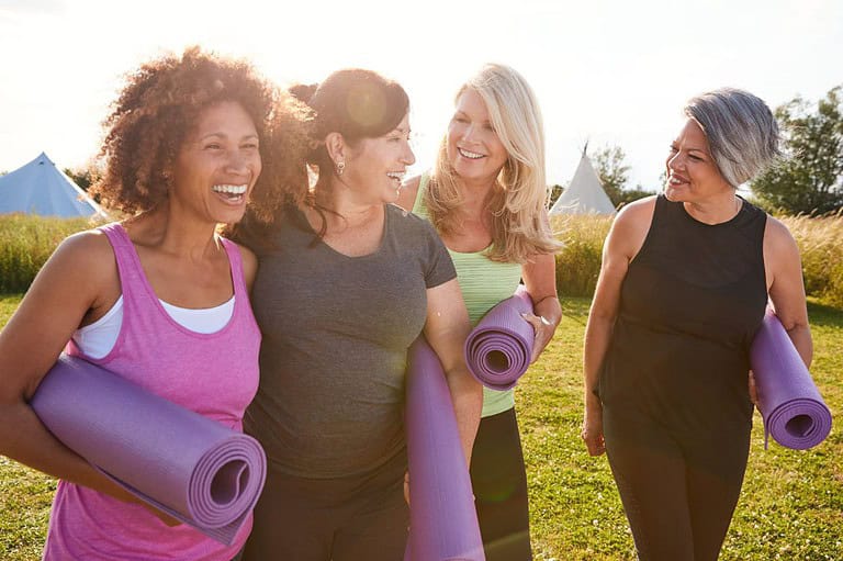 Group of women from Ohio doing yoga outdoors. Discover Ohio's most incredible retreats and wellness adventures that will leave you feeling refreshed, rejuvenated, and inspired!