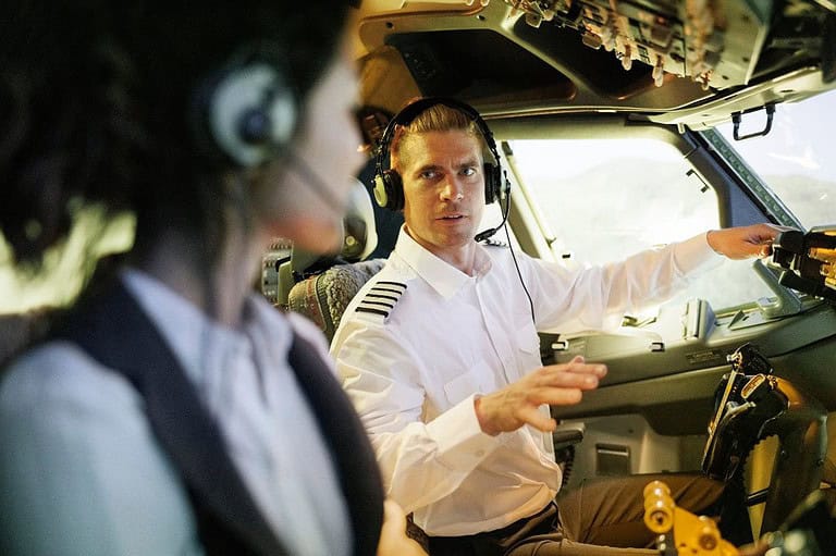 Pilot and co-pilot in cockpit. Pilots confess the shocking truths about what really happens in the sky! Get ready to have your mind blown by these aviation secrets.