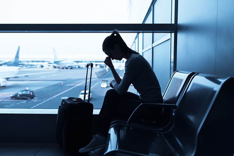 Stressed woman at airport. Flying out of the Midwest? Choose your airport wisely! You might want to avoid these delay-prone destinations!