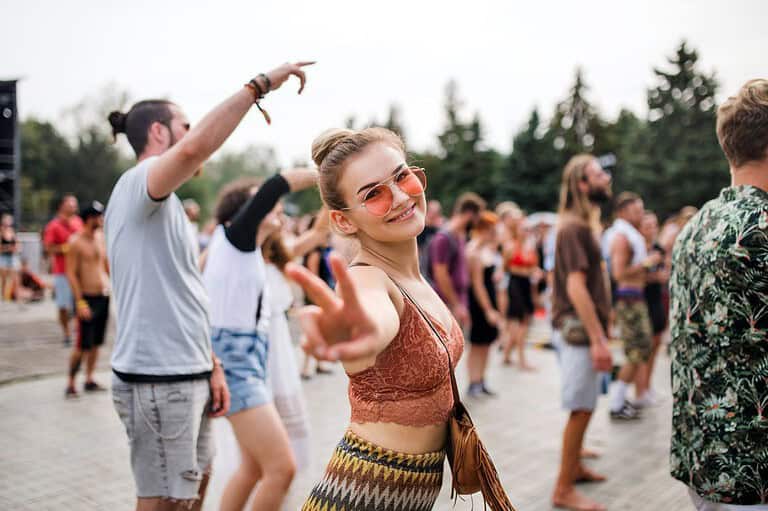 Solo female traveler at music festival. Ready to embrace the freedom of attending a music festival solo? Discover why going alone might just be the best decision you'll make!