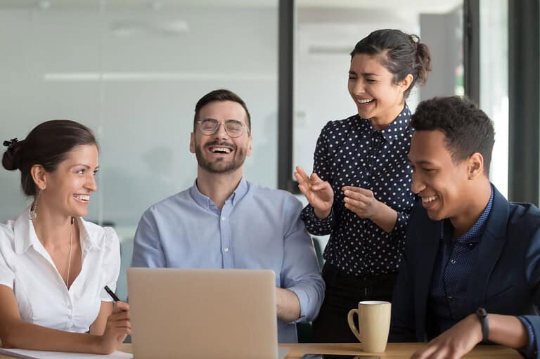 Office workers laughing at dad jokes. The best jokes to brighten up your workday. Get your colleagues laughing with our ultimate collection of dad jokes for the workplace!