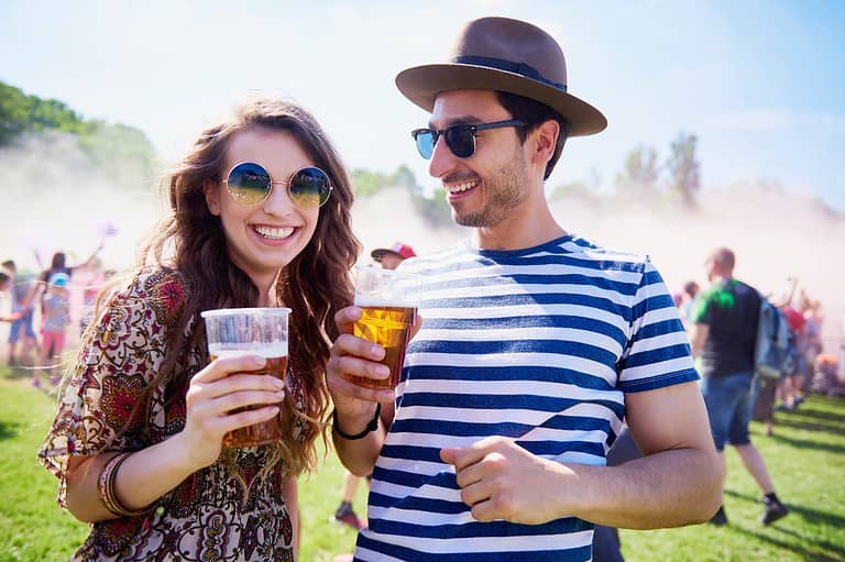 Happy couple from Duluth, MN drinking beer. Sip, savor, and celebrate with over 90 Minnesota breweries at the iconic All Pints North Summer Beer Festival on the shores of Lake Superior!