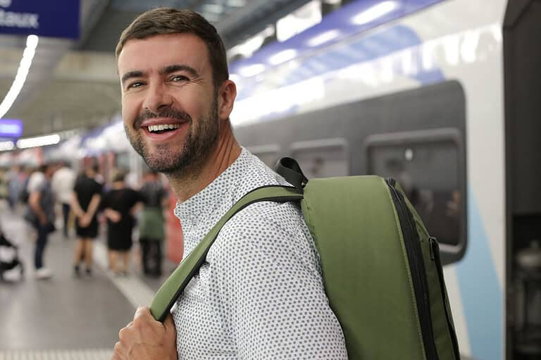 Man traveling by train in Minnesota. Attention Midwestern travelers! Check out these easy (and affordable) tips for exploring our neck of the woods sustainably.