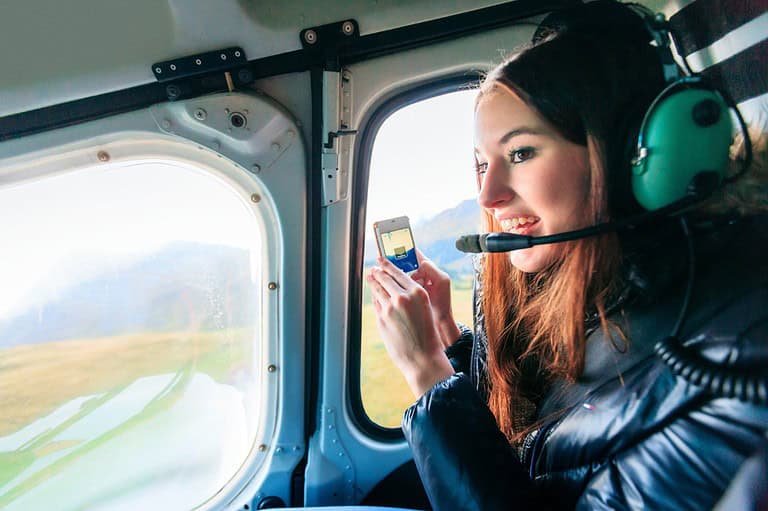 Minnesota woman in Duluth helicopter ride. Ready for the ultimate Minnesota adventure? Soar above Duluth and Lake Superior on a breathtaking private helicopter tour!