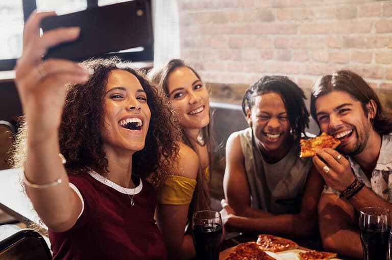 Friends eating pizza in Minneapolis. Attention, Minneapolis foodies! Discover incredible destinations that will tantalize your taste buds in the Twin Cities!