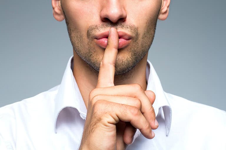 Office worker whispering secret. Millennials are mastering the art of stealth getaways and revolutionizing the way we think about PTO! Sneaky sneaky!