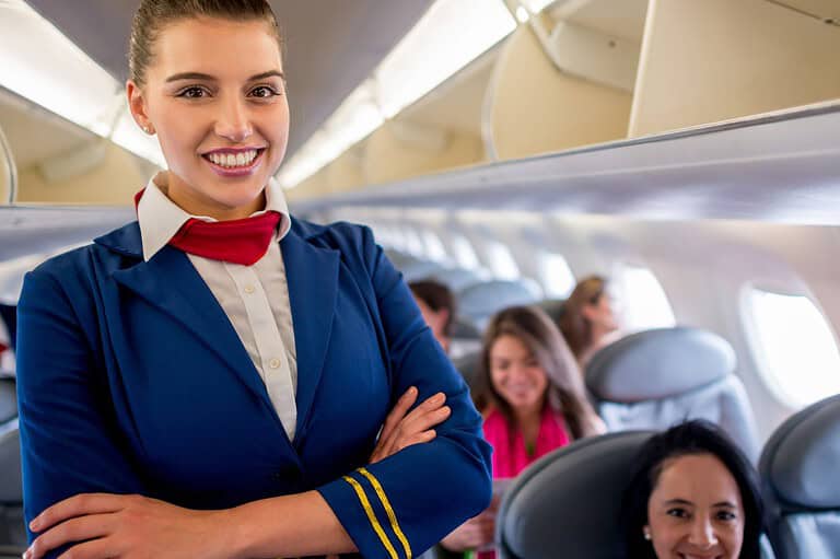 Flight attendant on plane. Flight attendants spill the tea! This is how you can elevate your next flight with these little-known free amenities, straight from the pros!