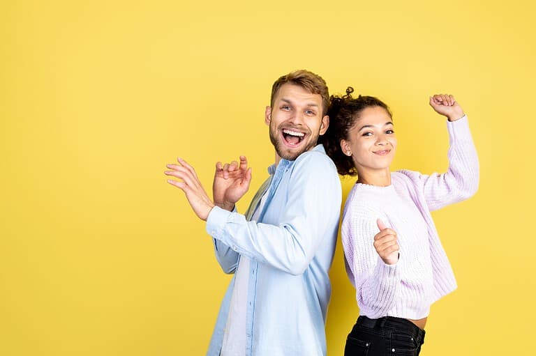 Happy people against yellow background. You'll never guess which U.S. city has been crowned the happiest! Click to reveal the answer and discover its secrets to joy.