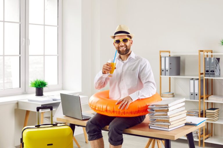 Man ready for vacation sitting on office desk, funny. Ready to laugh through the heat? Check out our hottest July jokes that will make your summer sizzle with giggles!