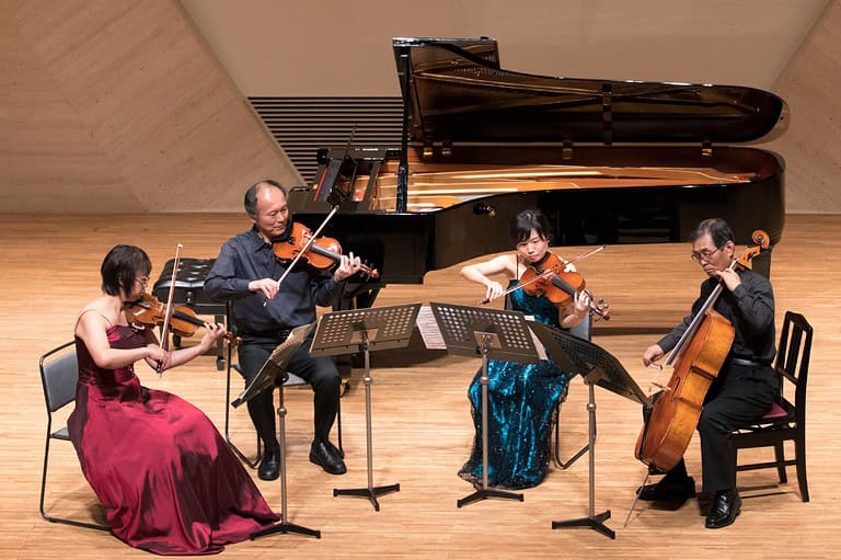 String quartet performs on stage. Get ready to be enchanted by a dazzling array of classical music virtuosos at the 2024 Minnesota Beethoven Festival in Winona, MN!