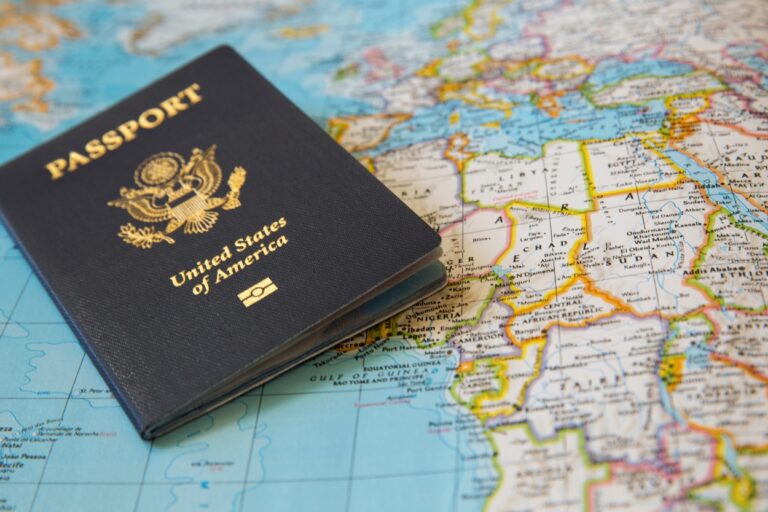 Passport and a world map. There's a critical passport error that could leave you stranded at the border and turn your dream vacation into a nightmare!