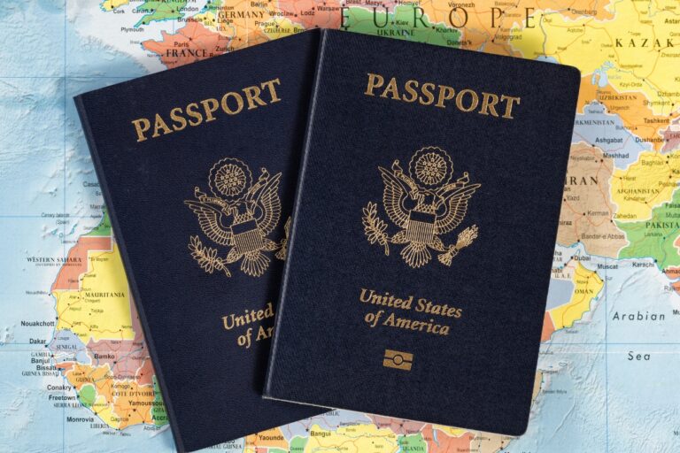 Two US passports on a world map. Jet off to your dream destination with confidence – our ultimate guide to passports and passport renewal has you covered!