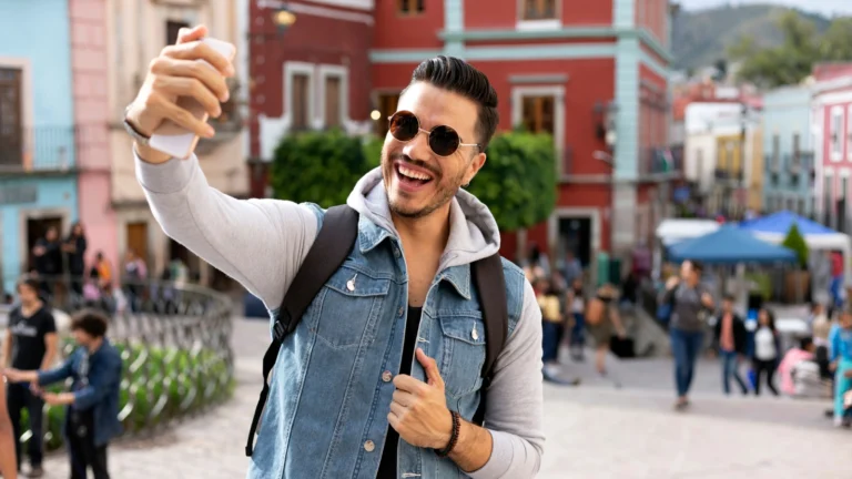 Hipster man taking selfie while traveling. Redditors are sharing their best-kept secrets for scoring free perks while traveling. You won’t believe the hacks they’ve uncovered!