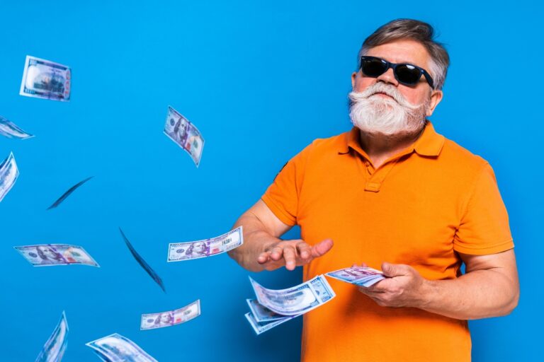 Funny older man making it rain with money. Ready to laugh your way to financial freedom? Check out our favorite money jokes that are guaranteed to make you smile!